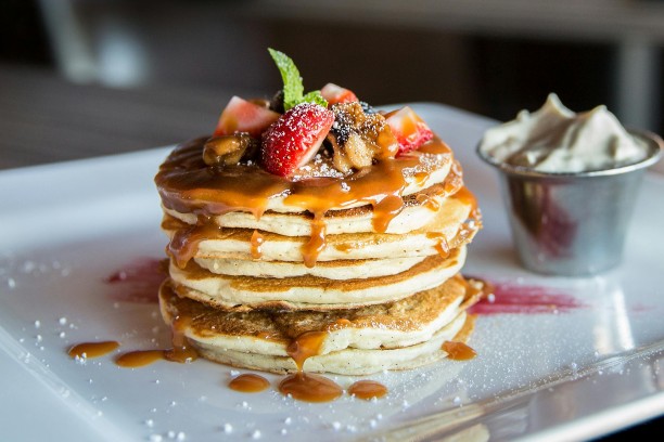 Pancakes topped with fruit and syrup Pancakes topped with fruit and syrup