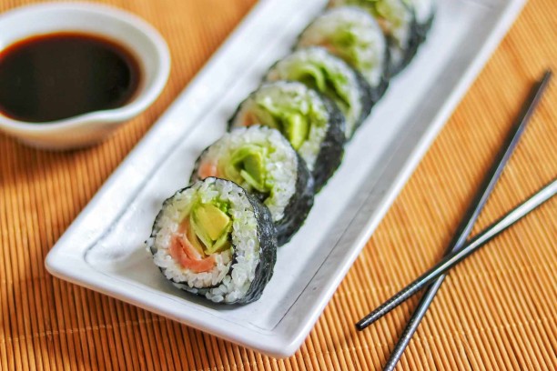 A plate of sushi with chopsticks
